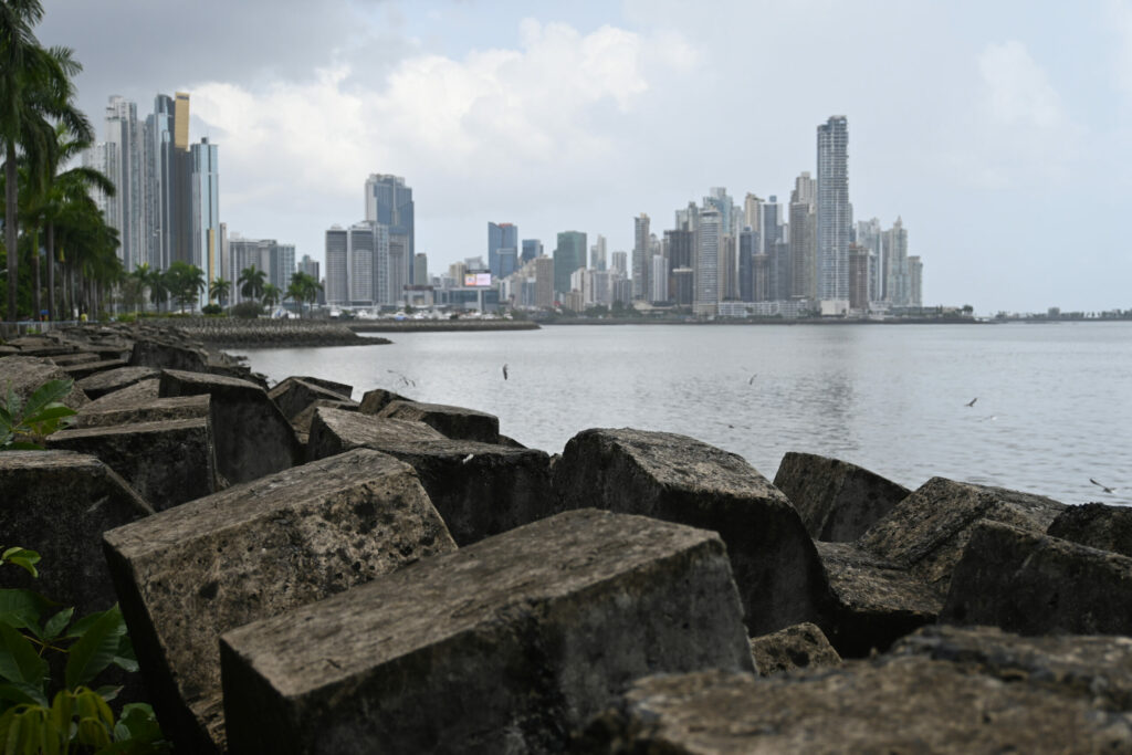 Stones in front, sea and Panama City skyline in the background