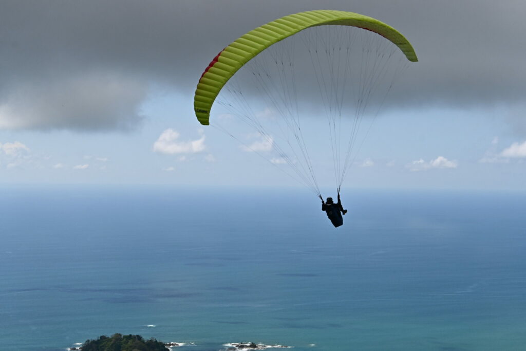 Paraglider with sea in the background, turning