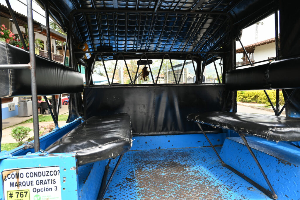 Looking into the back of a jeep with a bench on each side