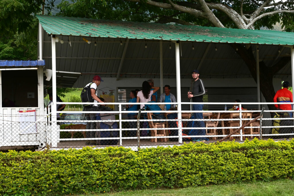 People standing in an open bar with beer