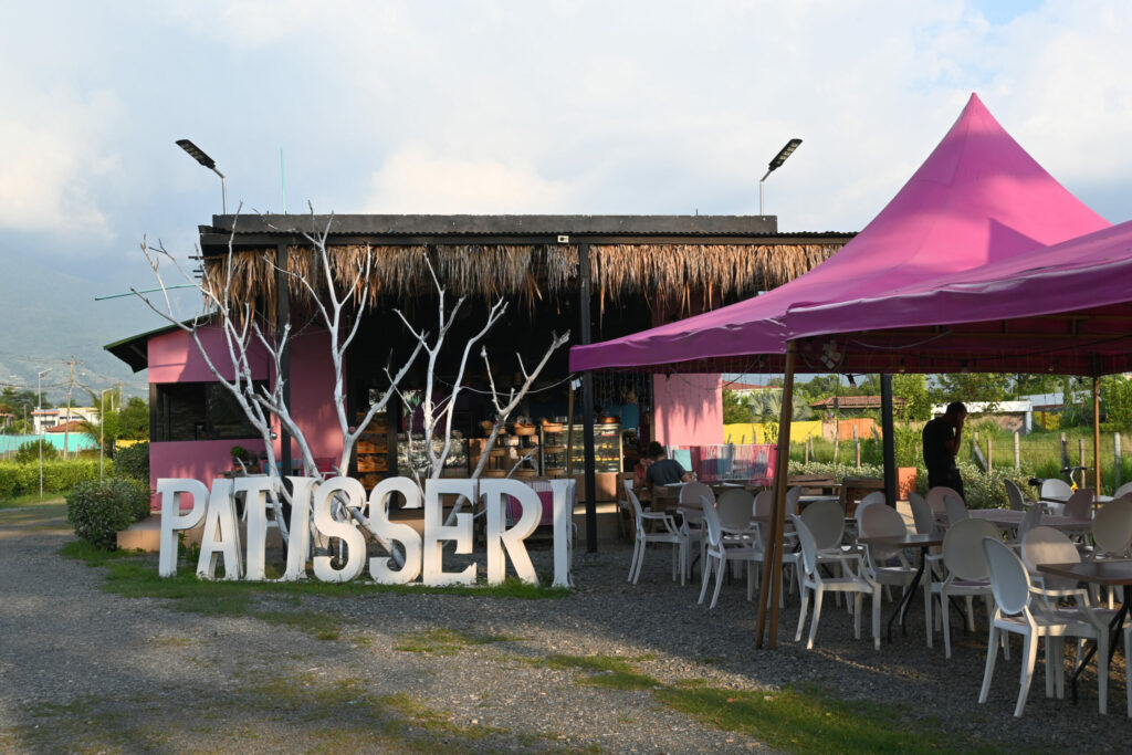 Cafè with large PATISSERI letters in front of an outside sitting area