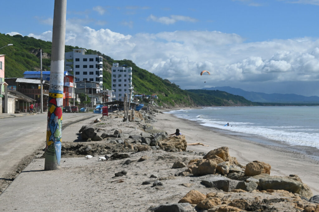 a beach strip with buildings to the left