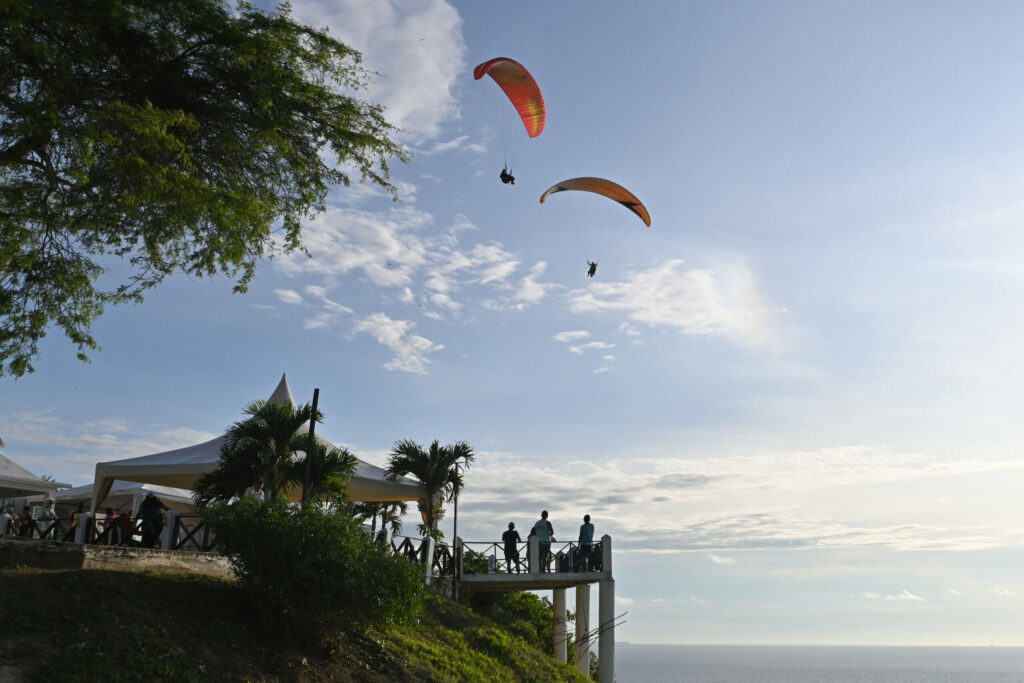 two Paraglider with a restaurant below