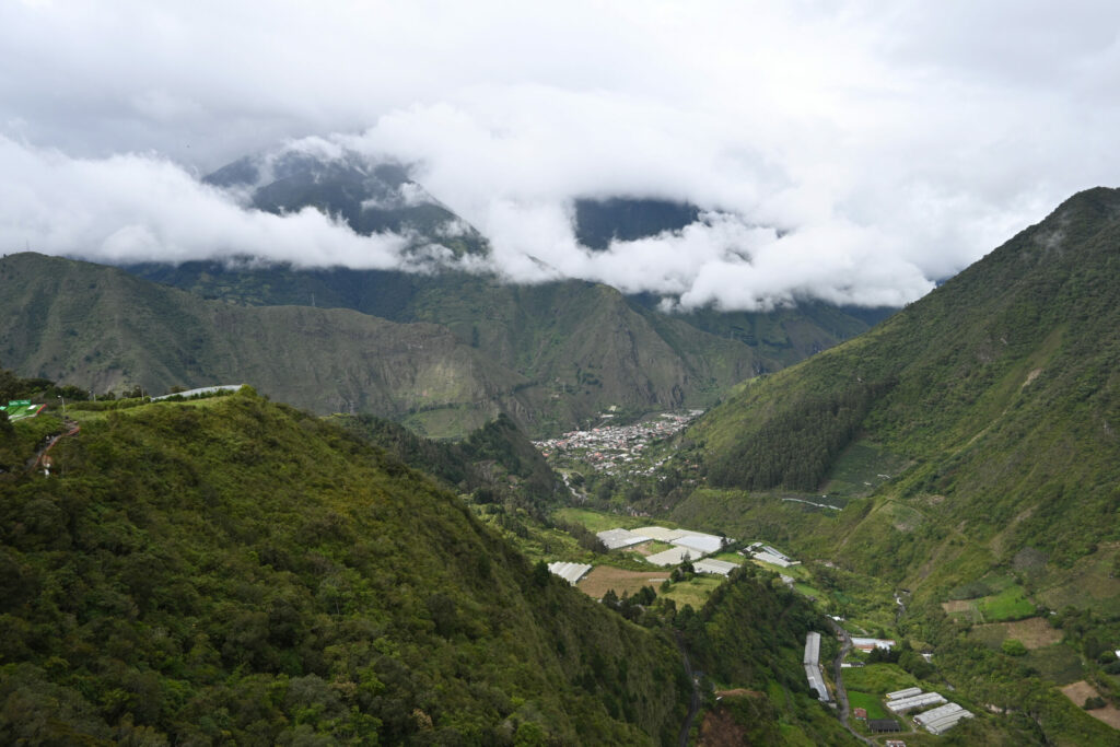 Narrow green valley with a town below