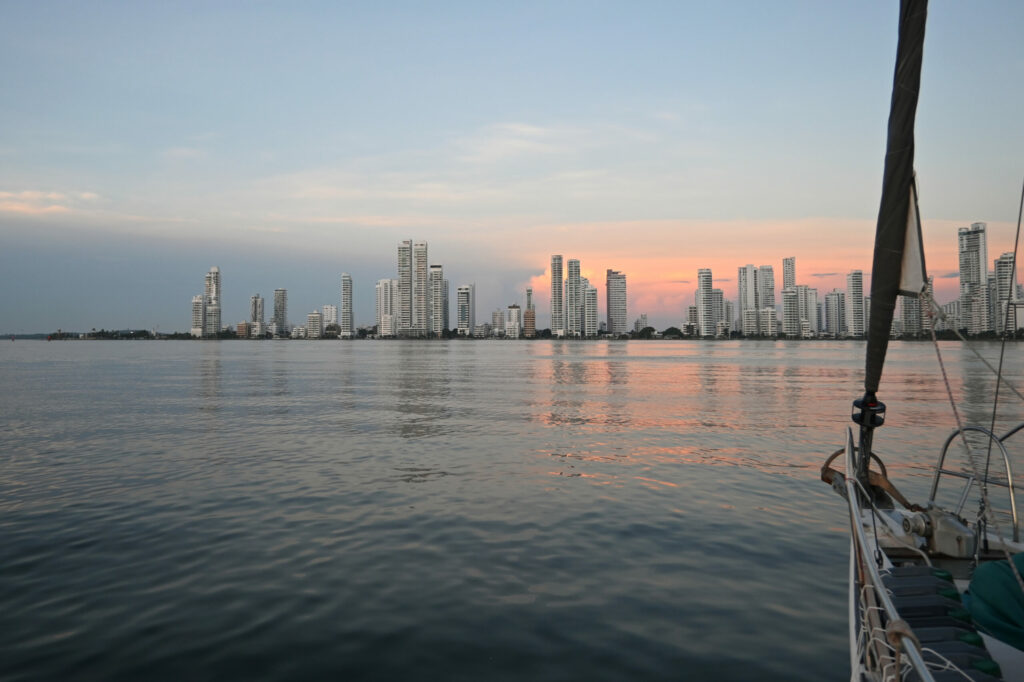 Cartagena skzline in the background, water and a sailing ship in the foreground